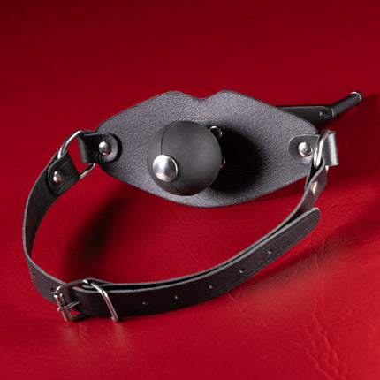 Front view of black lip-shaped leather gag panel with silicone ball and buckle strap