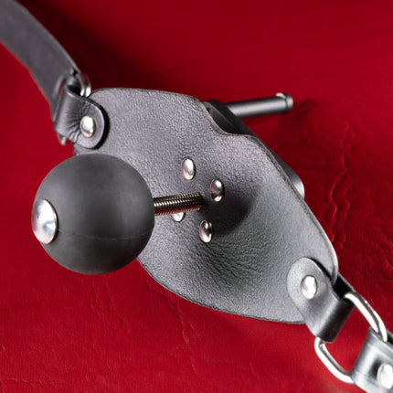 Matte black silicone ball with steel cap on screw behind leather gag panel