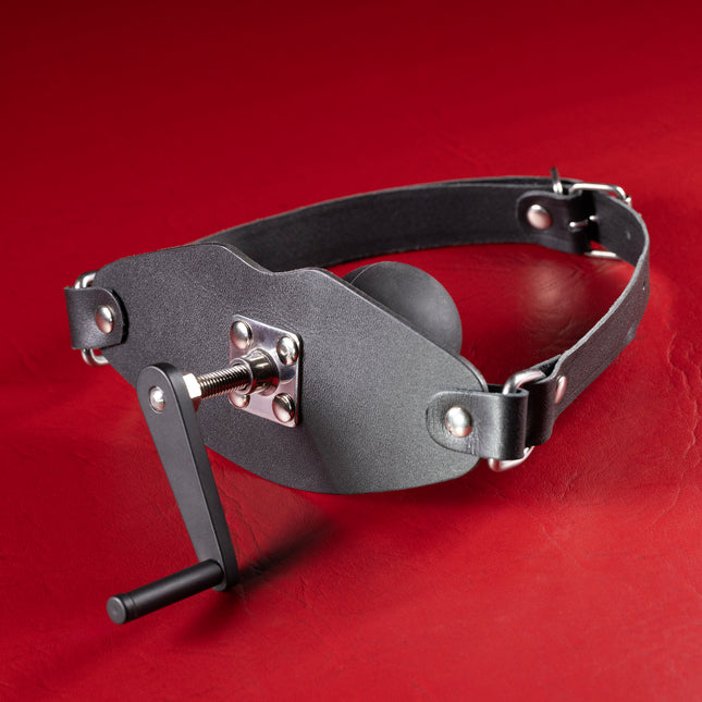 Stuff It Ball Gag with Hand Crank, black leather mouth panel with crank handle and silicone ball