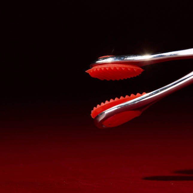Close-up of ridged red silicone pads on Forceps by KINK
