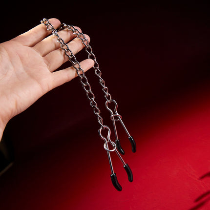 Jumbo Tweezer Clamps by KINK with heavy chain held in hand